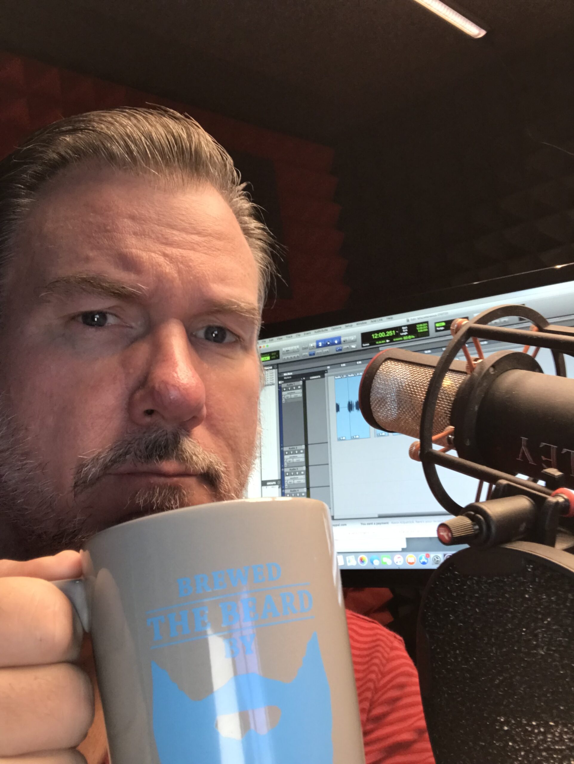 Kevin enjoying a cup of coffee with Eric Romanowski’s coffee mug in the studio.