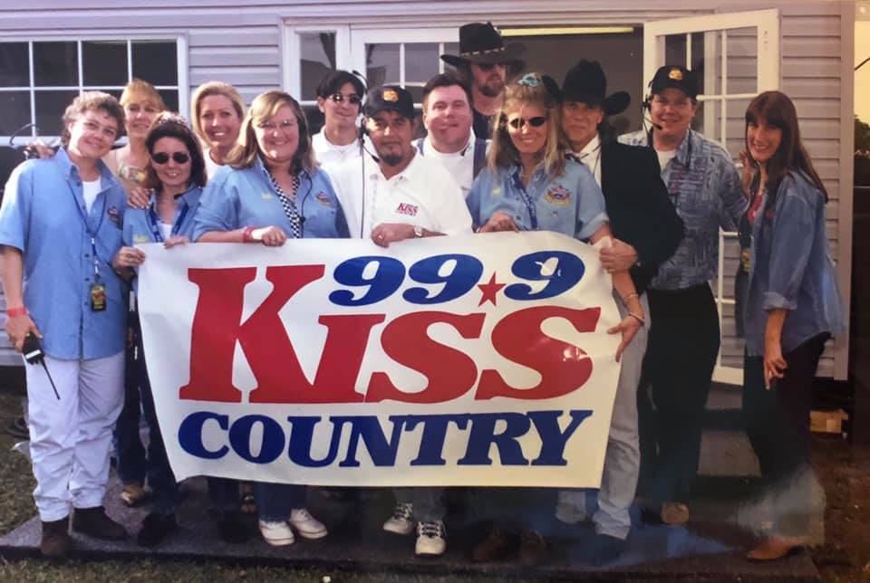 Kevin sticking out his tongue when he was “Gator” on 99-9 Kiss-Country in Miami.  Featured in the photo are Darlene Evans, Haley Kelly, Debbie Blake, Jan Halas, Sandy Funk, Ron Hersey, Janet Stonger Speziele Fox and others. Photo courtesy of Jan Halas.